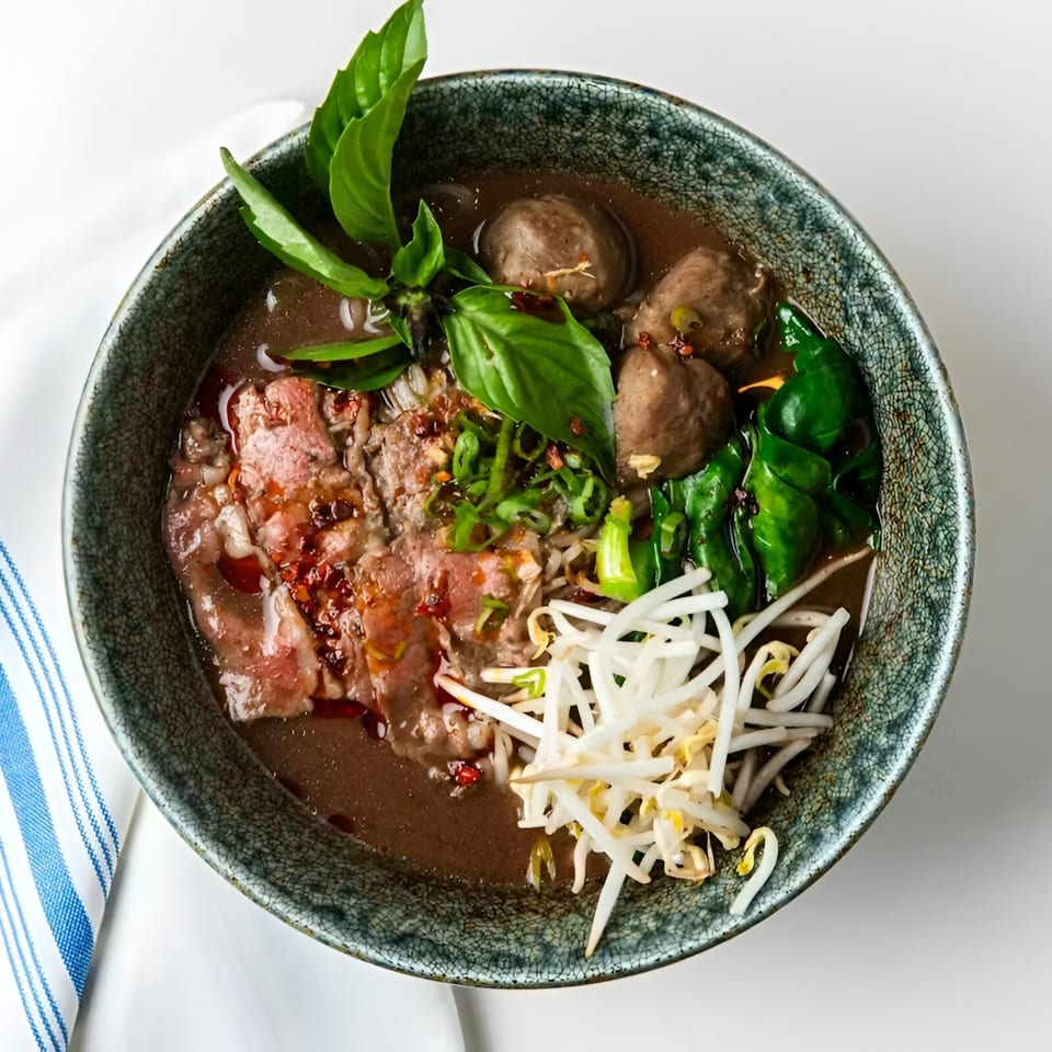 Osha Thai Kitchen's beef noodle soup with meatballs, bean sprouts, and fresh basil.