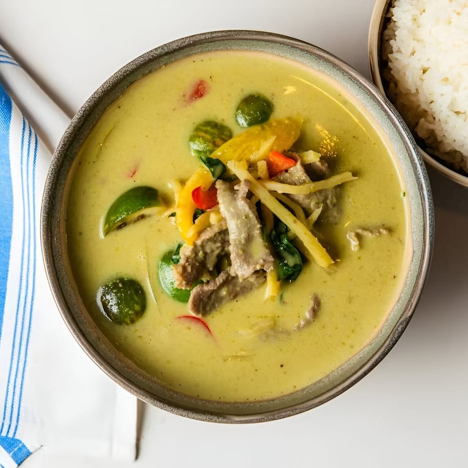 Osha Thai Kitchen's green curry with beef, bamboo shoots, bell peppers, and Thai eggplant, served with rice.