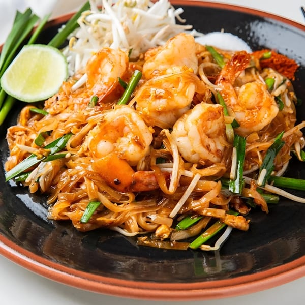 Osha Thai Kitchen's Pad Thai with shrimp, noodles, bean sprouts, green onions, and a lime wedge.